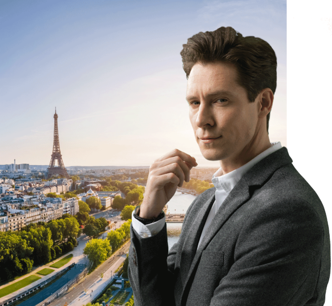 Image of a man with a background of the city of Paris in the background